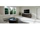 Bright living room featuring a comfy sectional sofa and large windows at 9417 Rawson Ave, Raleigh, NC 27613