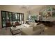 Open concept living area with modern kitchen, breakfast bar, and access to backyard patio at 9413 Rawson Ave, Raleigh, NC 27613