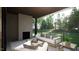 Relaxing covered patio with outdoor seating and a fireplace, overlooking the backyard at 9413 Rawson Ave, Raleigh, NC 27613