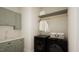 Bright laundry room with green cabinets, washer, dryer, and ample shelving at 9413 Rawson Ave, Raleigh, NC 27613
