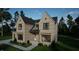 Brick two-story house with a charming front porch and landscaping at 9413 Rawson Ave, Raleigh, NC 27613
