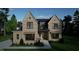 Modern farmhouse style home with a brick facade and large windows at 9413 Rawson Ave, Raleigh, NC 27613