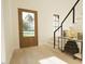 Light and airy entryway with wood floors, a wooden door, and modern staircase at 9413 Rawson Ave, Raleigh, NC 27613