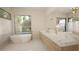 Elegant bathroom with double vanity, soaking tub and large windows at 9413 Rawson Ave, Raleigh, NC 27613