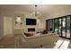 Bright living room features a fireplace, large TV, and sliding glass doors leading to a patio at 9413 Rawson Ave, Raleigh, NC 27613