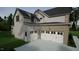 Modern farmhouse exterior with a three-car garage and landscaping at 9413 Rawson Ave, Raleigh, NC 27613