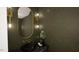 Elegant powder room with dark green walls, a black vessel sink, and gold accents at 9413 Rawson Ave, Raleigh, NC 27613