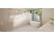 Spa-like bathroom with soaking tub, walk-in shower, and large window at 9413 Rawson Ave, Raleigh, NC 27613