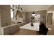 Bright kitchen features a sizable island, stainless steel appliances and white cabinetry at 9413 Rawson Ave, Raleigh, NC 27613