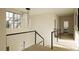 Bright hallway with modern light fixture and wooden floors at 9413 Rawson Ave, Raleigh, NC 27613