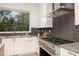 Modern kitchen with stainless steel appliances and large window at 515 W Lenoir St # 101, Raleigh, NC 27601