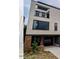 Modern three-story home with brick facade and attached garage at 515 W Lenoir St # 101, Raleigh, NC 27601
