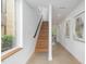Modern staircase with light wood treads and a sleek metal handrail at 515 W Lenoir St # 101, Raleigh, NC 27601