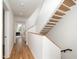 Modern hallway with light oak floors and a sleek floating staircase at 515 W Lenoir St # 101, Raleigh, NC 27601