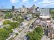 Drone shot showing the property's setting amongst other townhouses and the city skyline in the distance at 515 W Lenoir St # 101, Raleigh, NC 27601