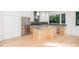 Modern kitchen with stainless steel appliances and an island at 515 W Lenoir St # 102, Raleigh, NC 27601