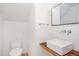 Modern bathroom with floating vanity and a wood shelf at 515 W Lenoir St # 102, Raleigh, NC 27601