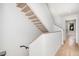 Modern floating staircase with light wood steps and white walls at 515 W Lenoir St # 102, Raleigh, NC 27601