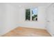 Light-filled bedroom with hardwood floors and large window at 515 W Lenoir St # 102, Raleigh, NC 27601