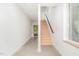 Bright hallway with light walls and wooden staircase at 515 W Lenoir St # 102, Raleigh, NC 27601