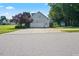 Rear view of house highlighting the garage and yard at 15 Meadow View Ct, Fuquay Varina, NC 27526