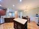 Open kitchen with large island and hardwood floors at 15 Meadow View Ct, Fuquay Varina, NC 27526