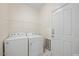 Laundry room with washer, dryer, and ample shelving at 15 Meadow View Ct, Fuquay Varina, NC 27526