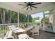 Screened porch with seating area and ceiling fan at 15 Meadow View Ct, Fuquay Varina, NC 27526