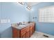 Double vanity bathroom with granite countertops and a large block window at 15 Meadow View Ct, Fuquay Varina, NC 27526