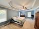 Main bedroom with carpeted floor, tray ceiling and ceiling fan at 15 Meadow View Ct, Fuquay Varina, NC 27526