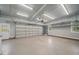 Garage with overhead storage and large garage door at 15 Meadow View Ct, Fuquay Varina, NC 27526