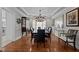 Elegant dining room, hardwood floors, chandelier, and seating for 10 at 4600 Scottland Dr, Mebane, NC 27302