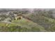 House nestled on a large lot with mature trees and a pond, seen from above at 4600 Scottland Dr, Mebane, NC 27302
