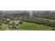 Aerial view of a home on a large lot with a pond and surrounding trees at 4600 Scottland Dr, Mebane, NC 27302