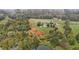 High-angle view of a house on a large lot with mature trees and a pond at 4600 Scottland Dr, Mebane, NC 27302
