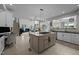 Bright kitchen with a large island, white cabinets, and stainless steel appliances at 4600 Scottland Dr, Mebane, NC 27302