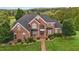 Brick two-story home with a large front yard and walkway at 4600 Scottland Dr, Mebane, NC 27302
