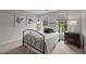 Well-lit bedroom with a comfortable bed and views of the backyard at 4600 Scottland Dr, Mebane, NC 27302