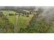 Aerial view showing a house, expansive grounds and a pond in the distance at 4600 Scottland Dr, Mebane, NC 27302