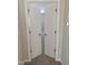 Open doors reveal a spacious bedroom with neutral carpeting at 727 Putney Hill Rd, Zebulon, NC 27597