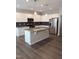 Modern kitchen with island and stainless steel appliances at 727 Putney Hill Rd, Zebulon, NC 27597