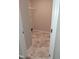 Laundry room with hexagon tile flooring and shelving at 727 Putney Hill Rd, Zebulon, NC 27597
