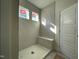 Large tiled shower with built-in seat and two windows at 1504 Maelyn Way, Fuquay Varina, NC 27526