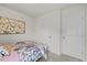 Simple bedroom with a double bed, large wall art, and plenty of closet space at 1261 Zoysia Dr, Rocky Mount, NC 27801