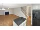 Living room with hardwood floors, fireplace and kitchen view at 104 Deerwalk Ct, Cary, NC 27513