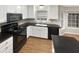 Modern kitchen with black appliances and granite countertops at 104 Deerwalk Ct, Cary, NC 27513