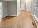 Hardwood floor living room with access to kitchen and other rooms at 104 Deerwalk Ct, Cary, NC 27513