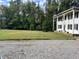 Two story home with gravel driveway and lawn at 1229 Tulip St, Clayton, NC 27520