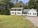 Two-story home with a long driveway and landscaping at 1229 Tulip St, Clayton, NC 27520