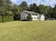 Two-story house with a large front yard and mature trees at 1229 Tulip St, Clayton, NC 27520